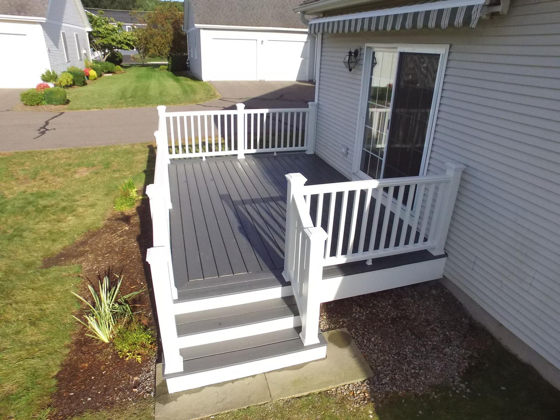 An aerial view of a house with a deck and stairs