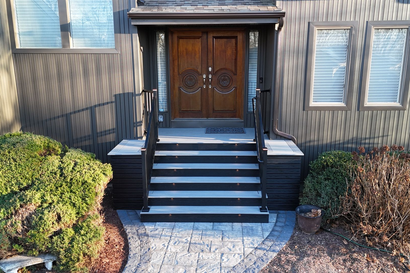 A porch with two chairs and a table on it