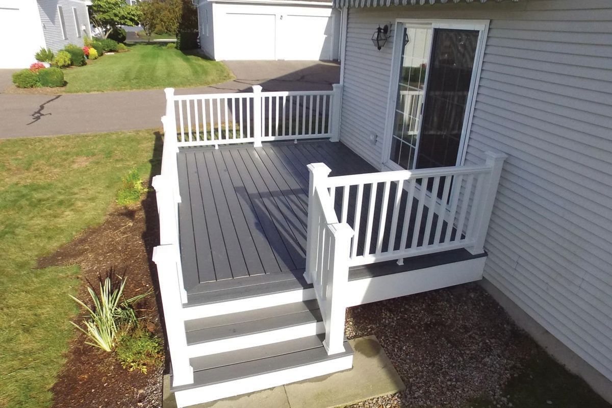An aerial view of a deck with stairs and a white railing