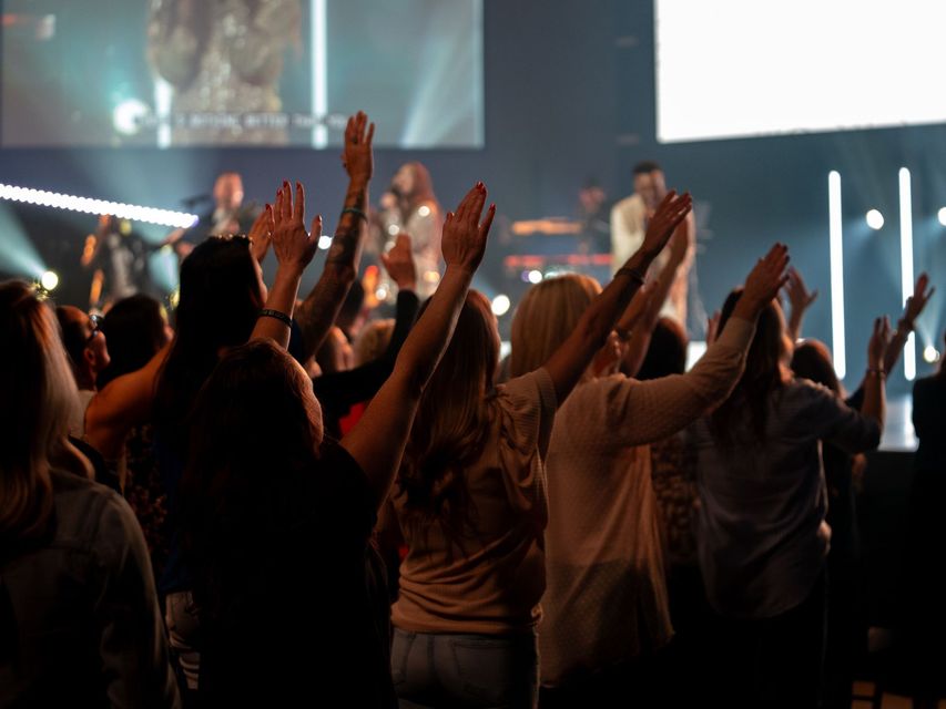 Women worshiping with hands raised