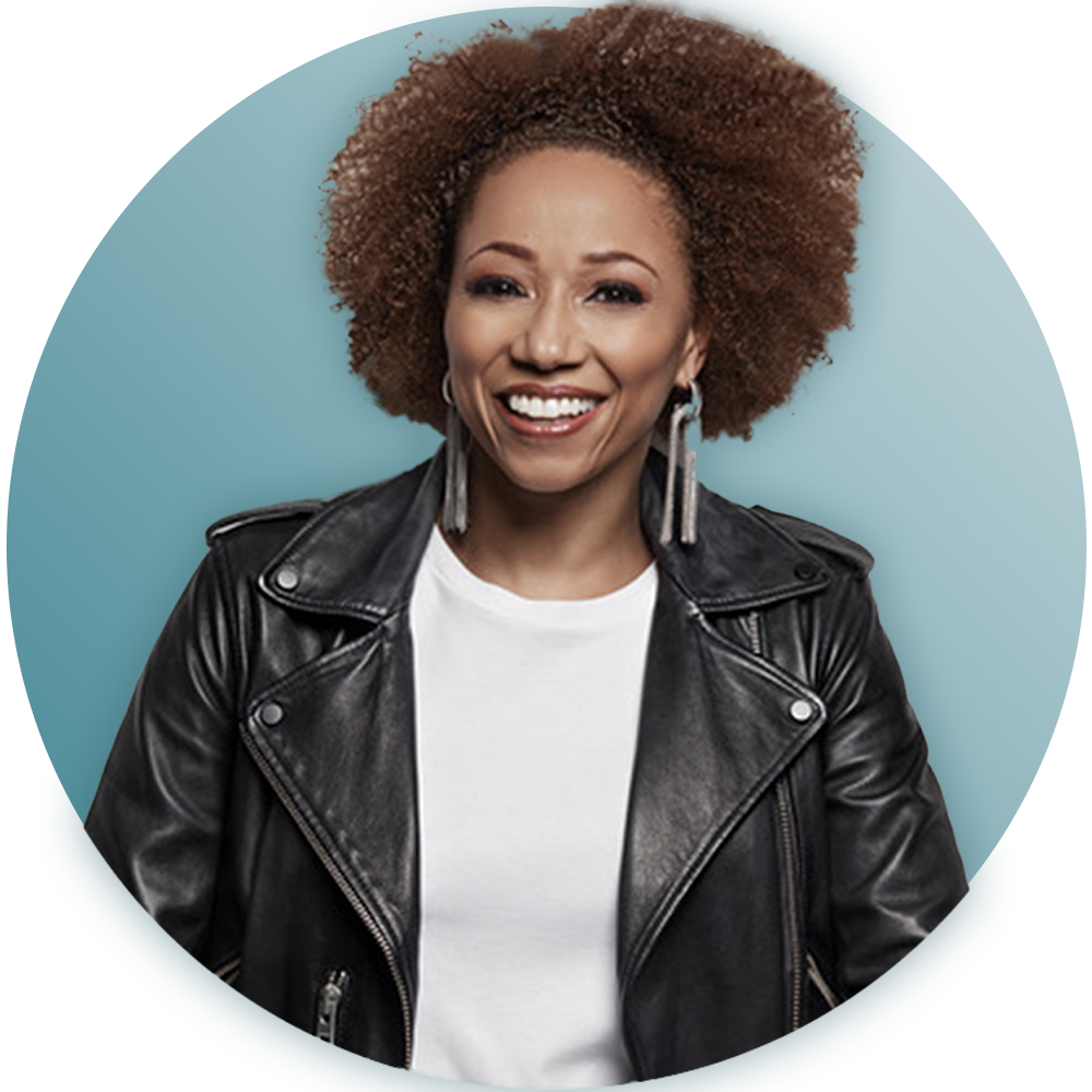 A woman wearing a black leather jacket and earrings is smiling