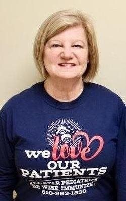 Woman smiling in navy shirt with 