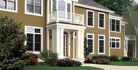 A large house with a lot of windows and a balcony