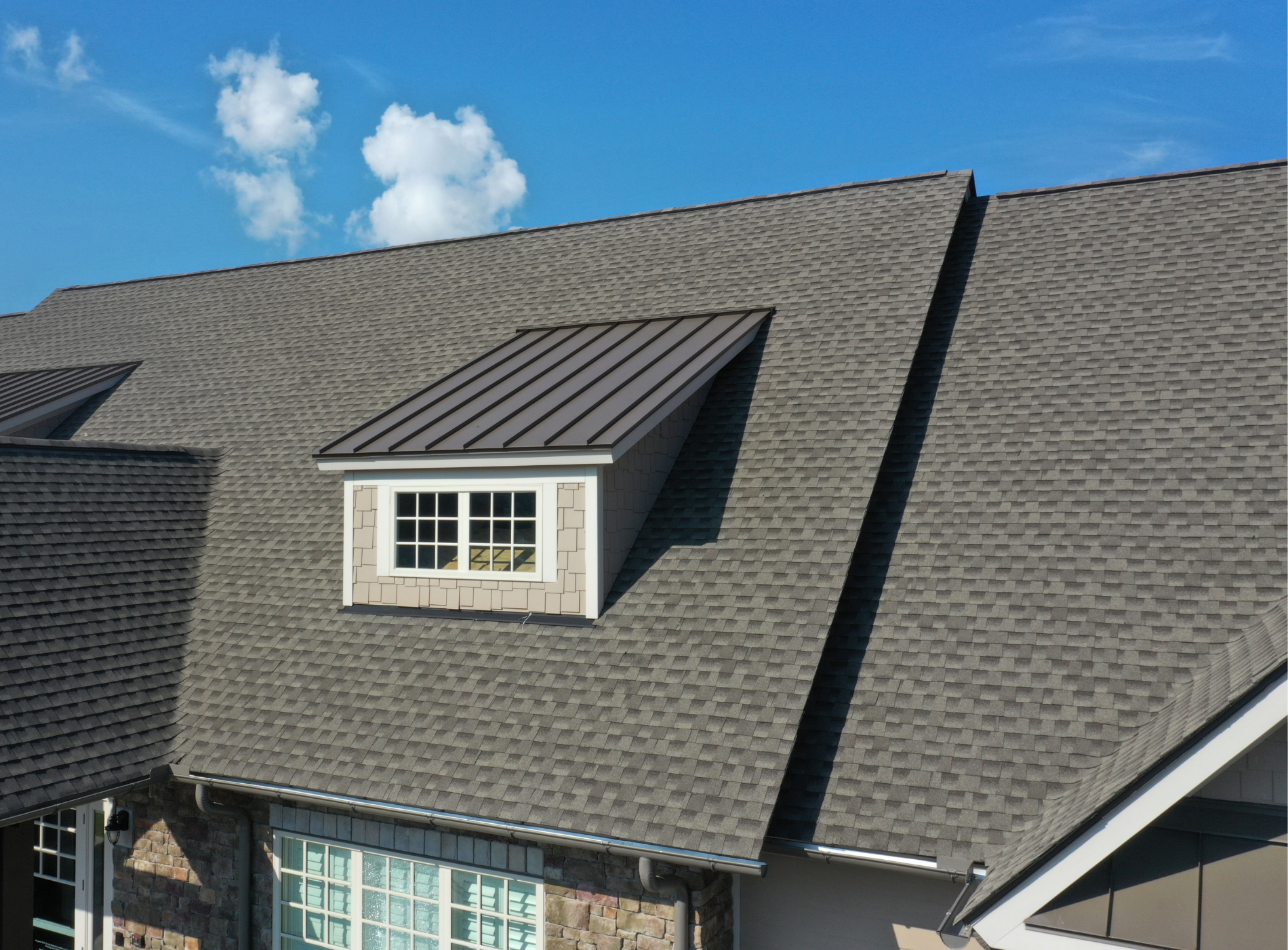 An aerial view of a house with a roof and a window.