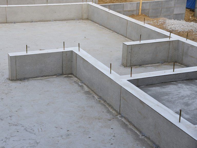 A concrete base for a house is being built.