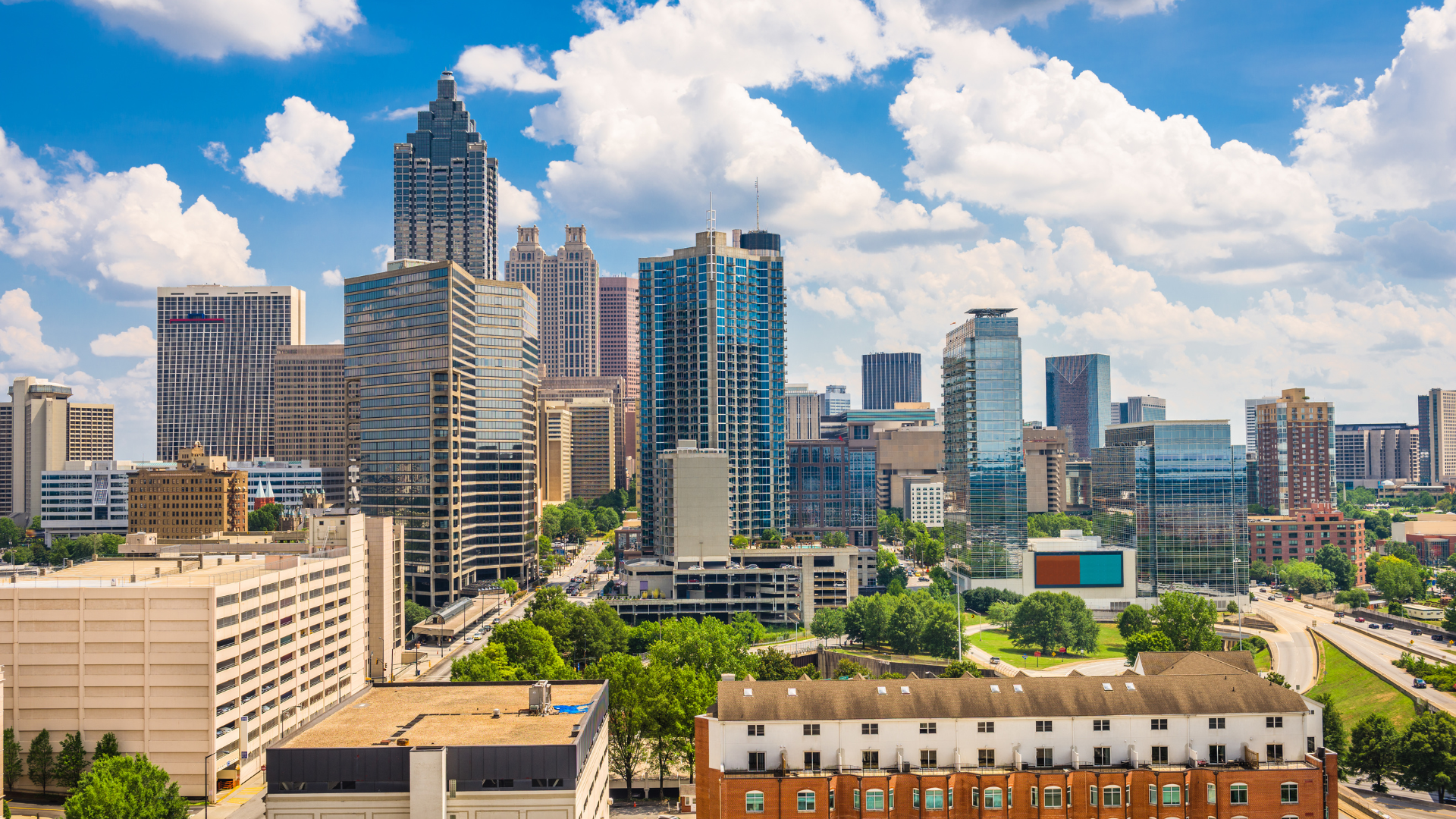 An aerial view of a city skyline on a sunny day.