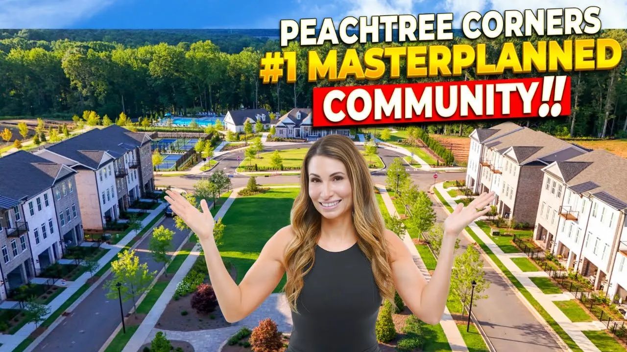 A woman is standing in front of a peachtree corners # 1 masterplanned community.
