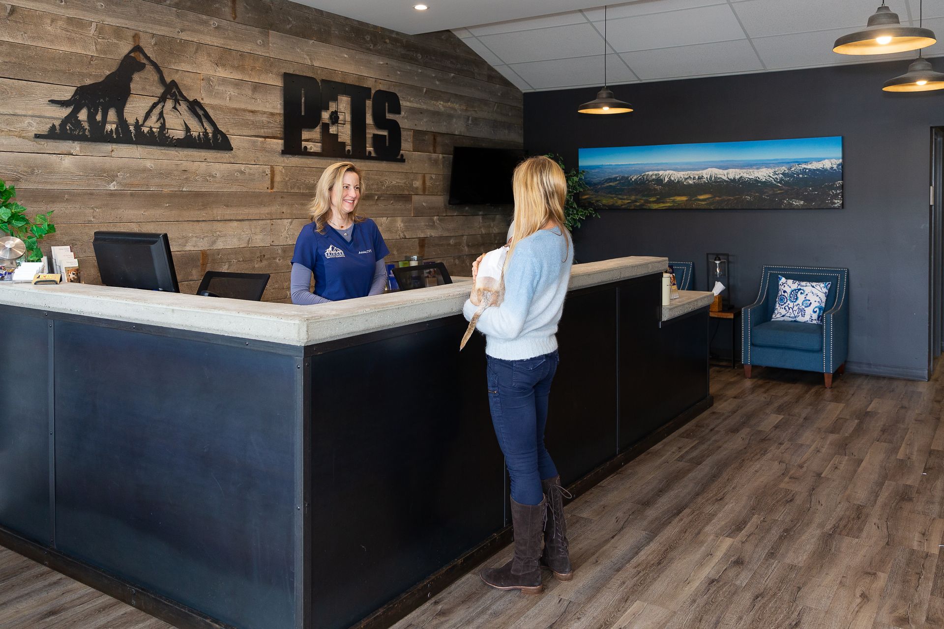 Hotel reception desk with a clerk assisting a guest in a modern lobby