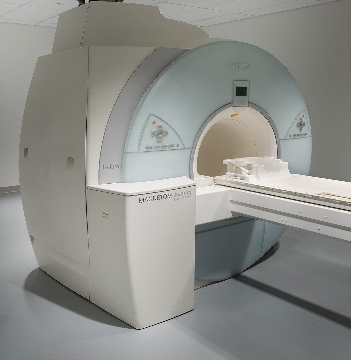 MRI scanner with a patient table in a medical imaging room