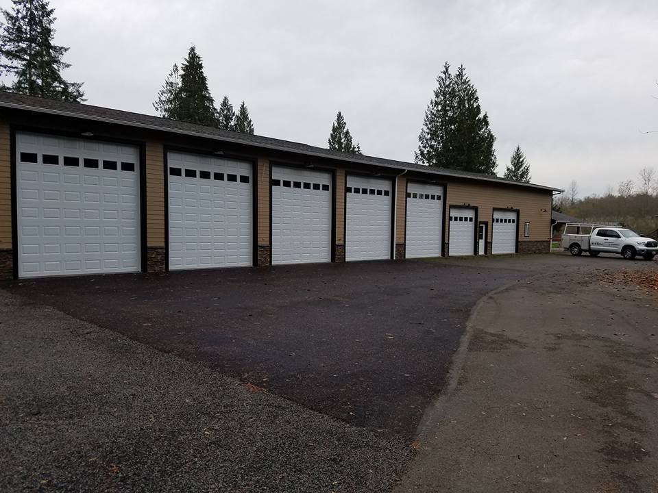 Row of commercial garage doors installed on shop building