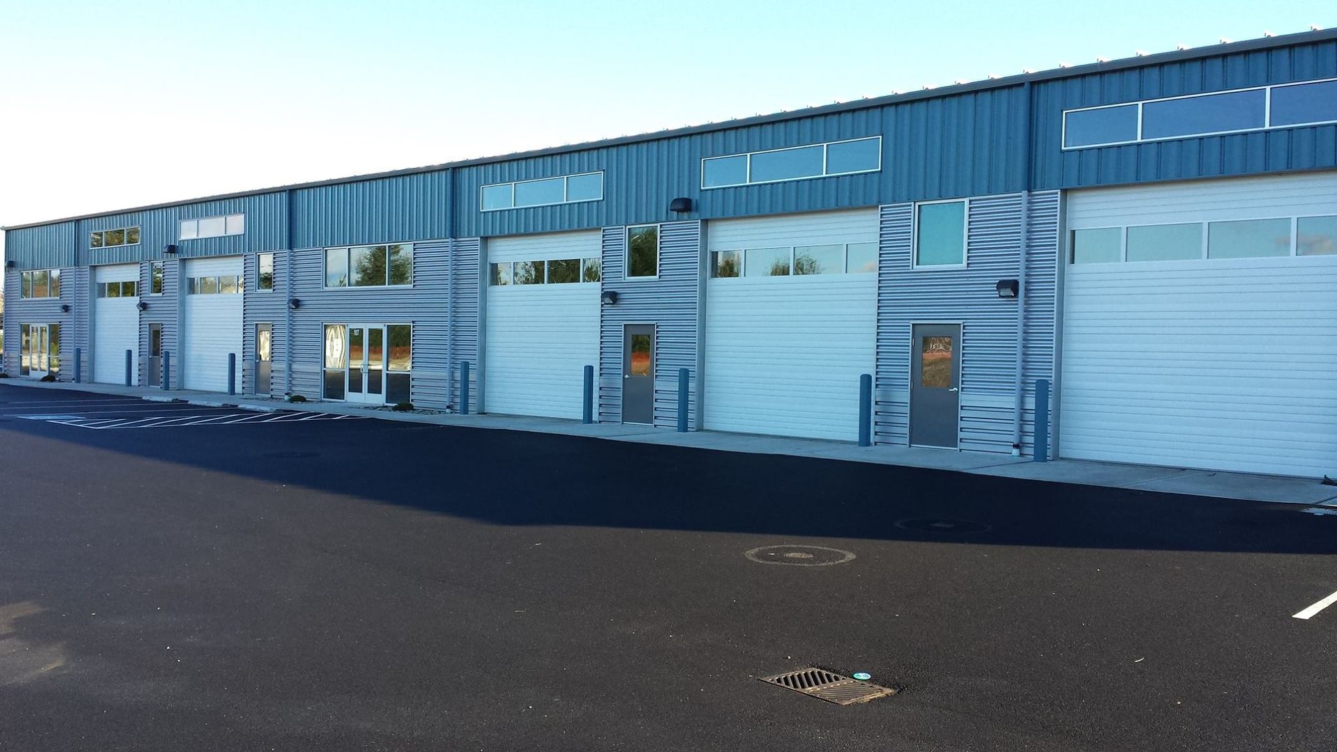 Large commercial building with multiple overhead garage doors