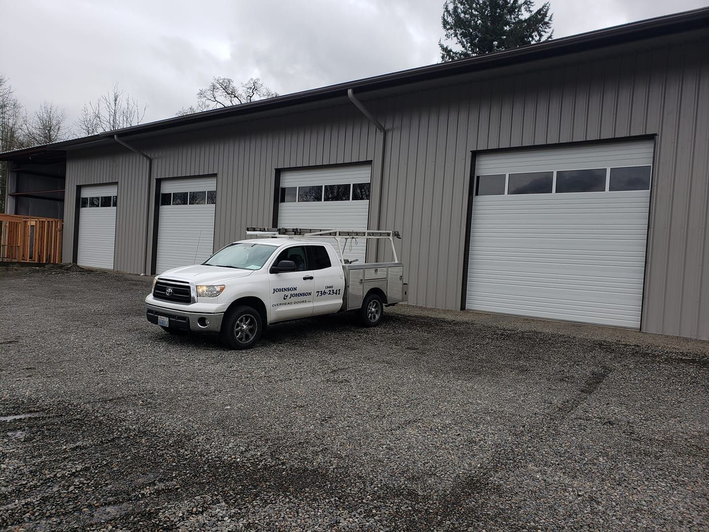 Service vehicle parked outside commercial garage door installation