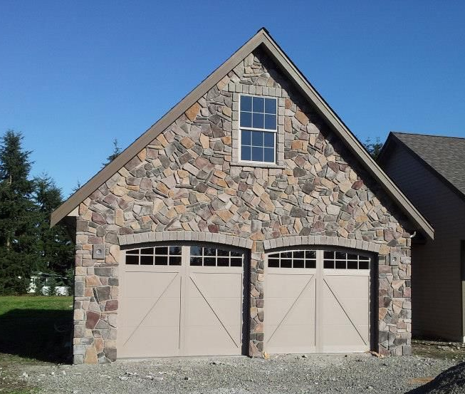 Carriage-style garage doors on stone-front home