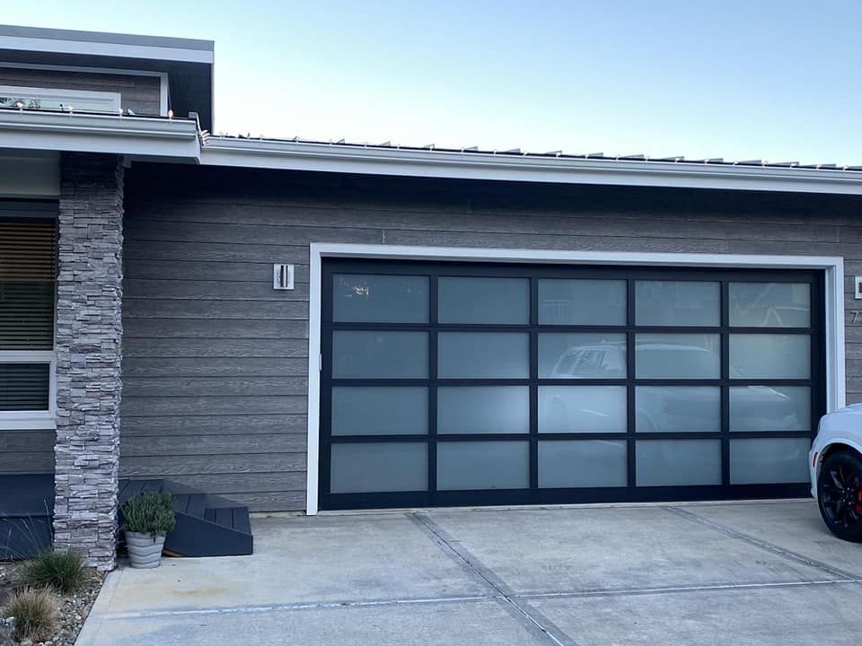 Contemporary black glass garage door on modern home exterior