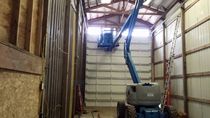 Garage door spring area accessed with Genie lift inside commercial building