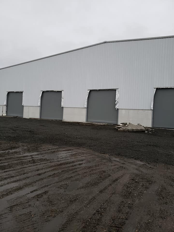 Commercial warehouse with multiple overhead garage door bays