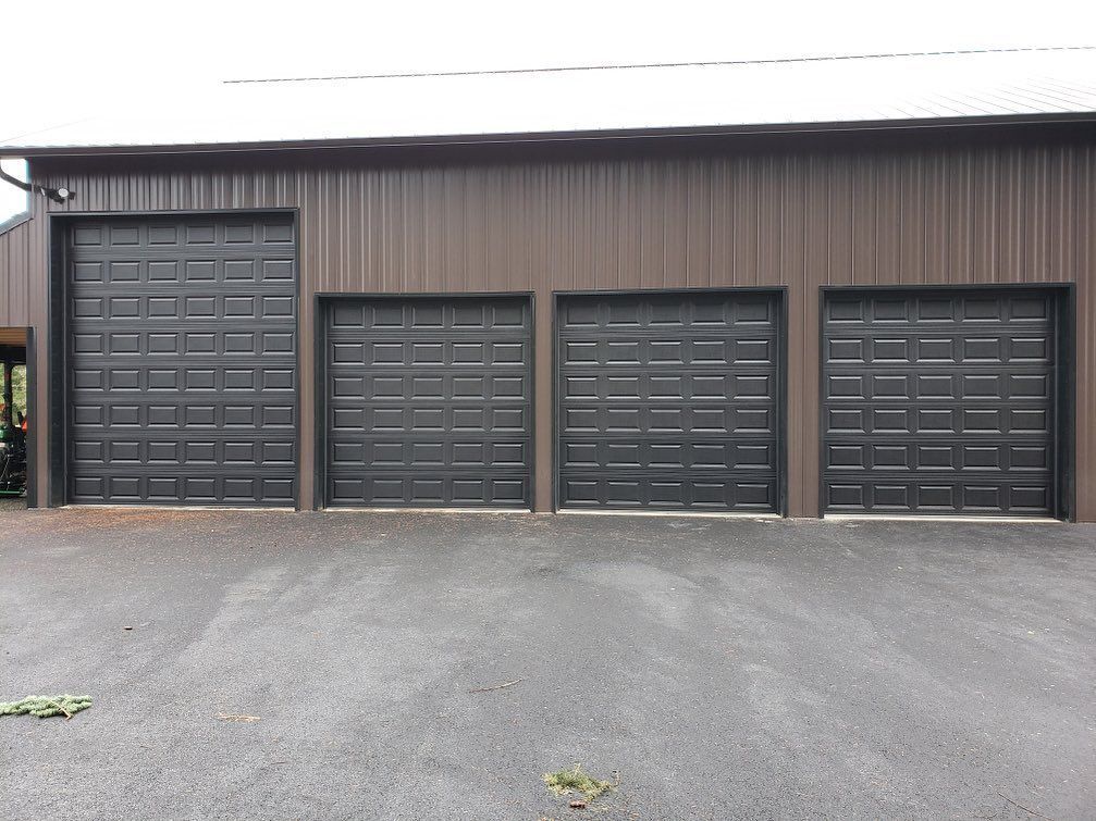 Multi-bay commercial garage doors installed on metal building