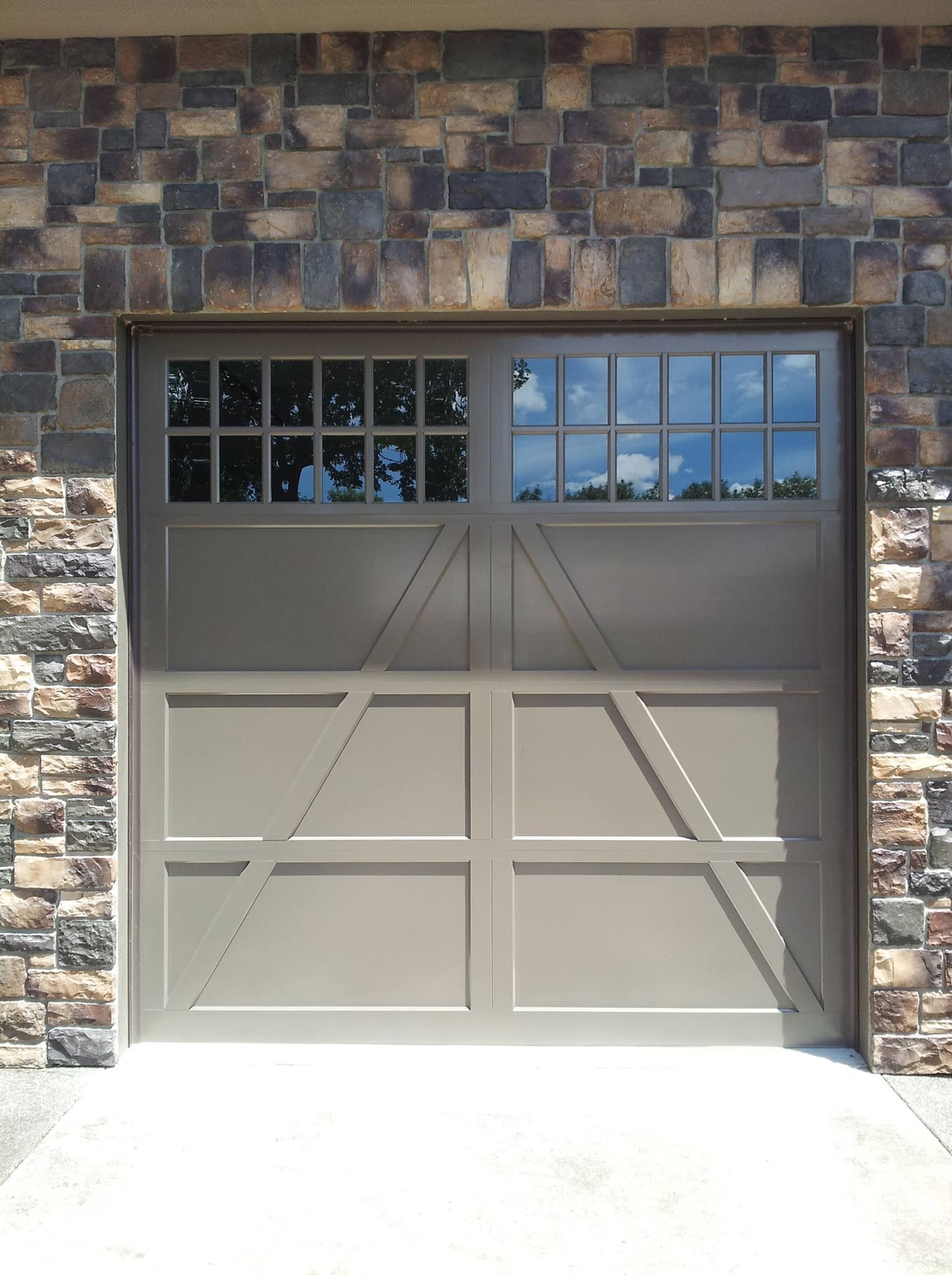 Beige metal-sided garage building with large overhead door