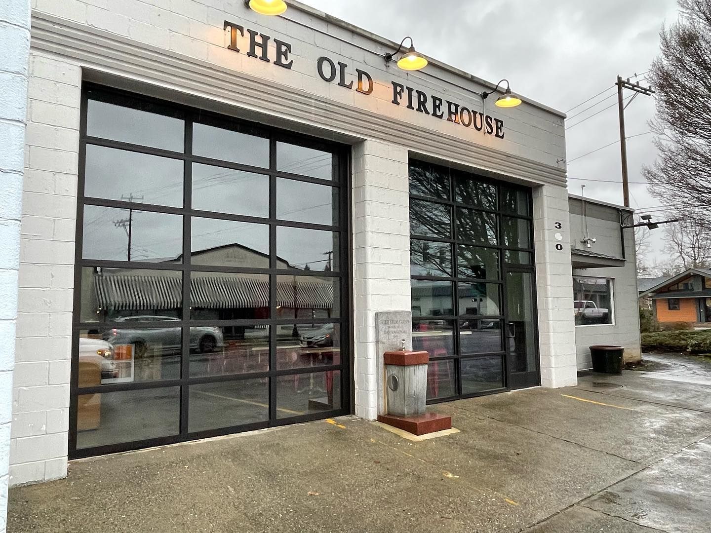 Commercial glass garage door installation on retail storefront building