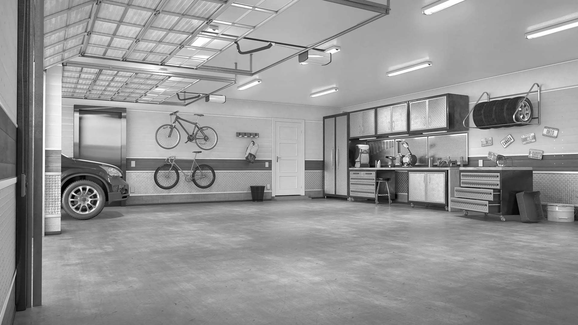 Spacious garage interior with a car, bicycle on the wall, and workbench cabinets along the back wall