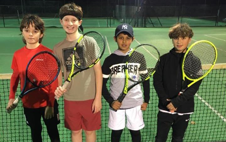 An image of four junior tennis players at Pinner Lawn Tennis Club