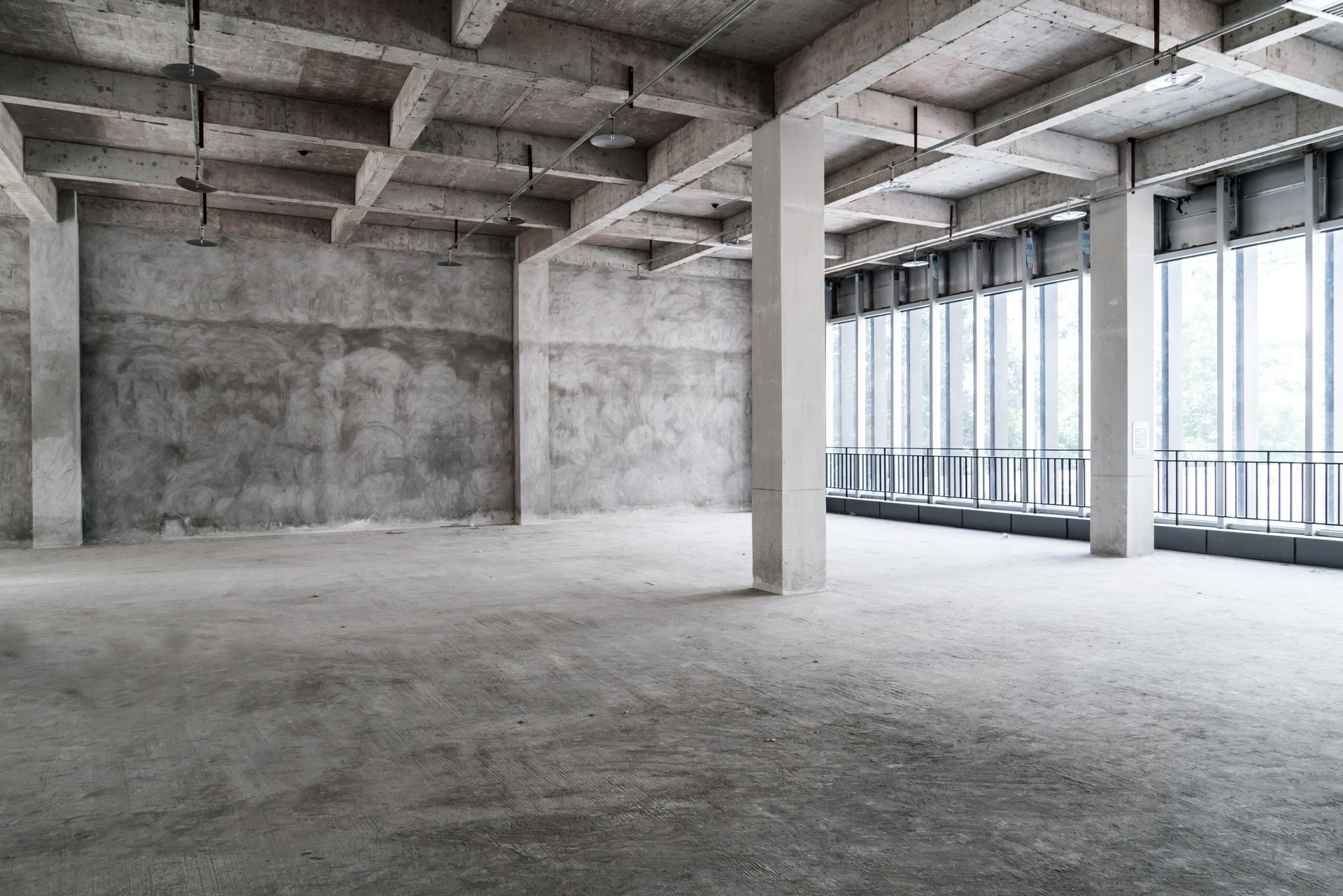 An empty building with a lot of windows and columns.