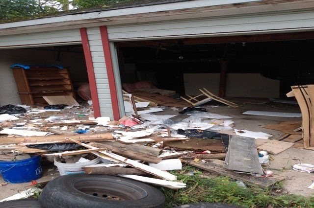 miscellaneous trash and tires inside and outside a garage