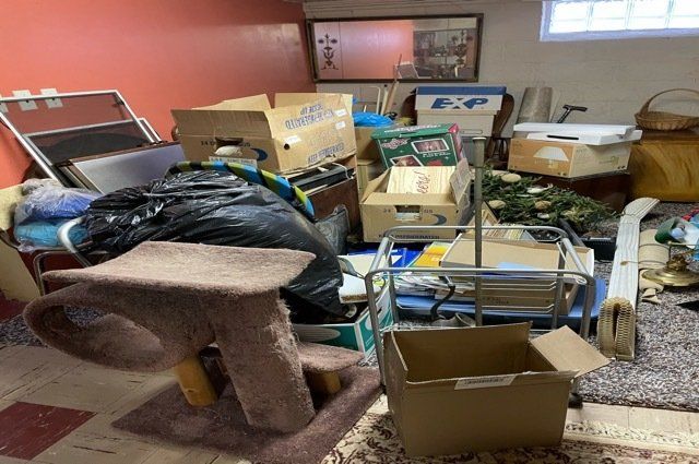 room with red and white walls full of miscellaneous junk on the floor
