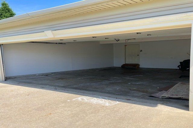 emptied out basement shelving and clean concrete floor