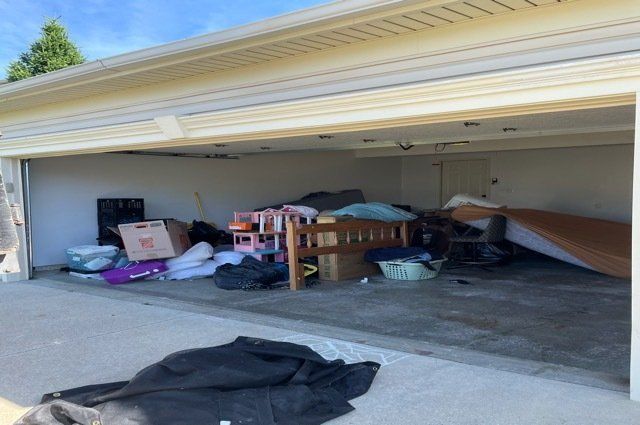 a bunch of junk on floor inside garage