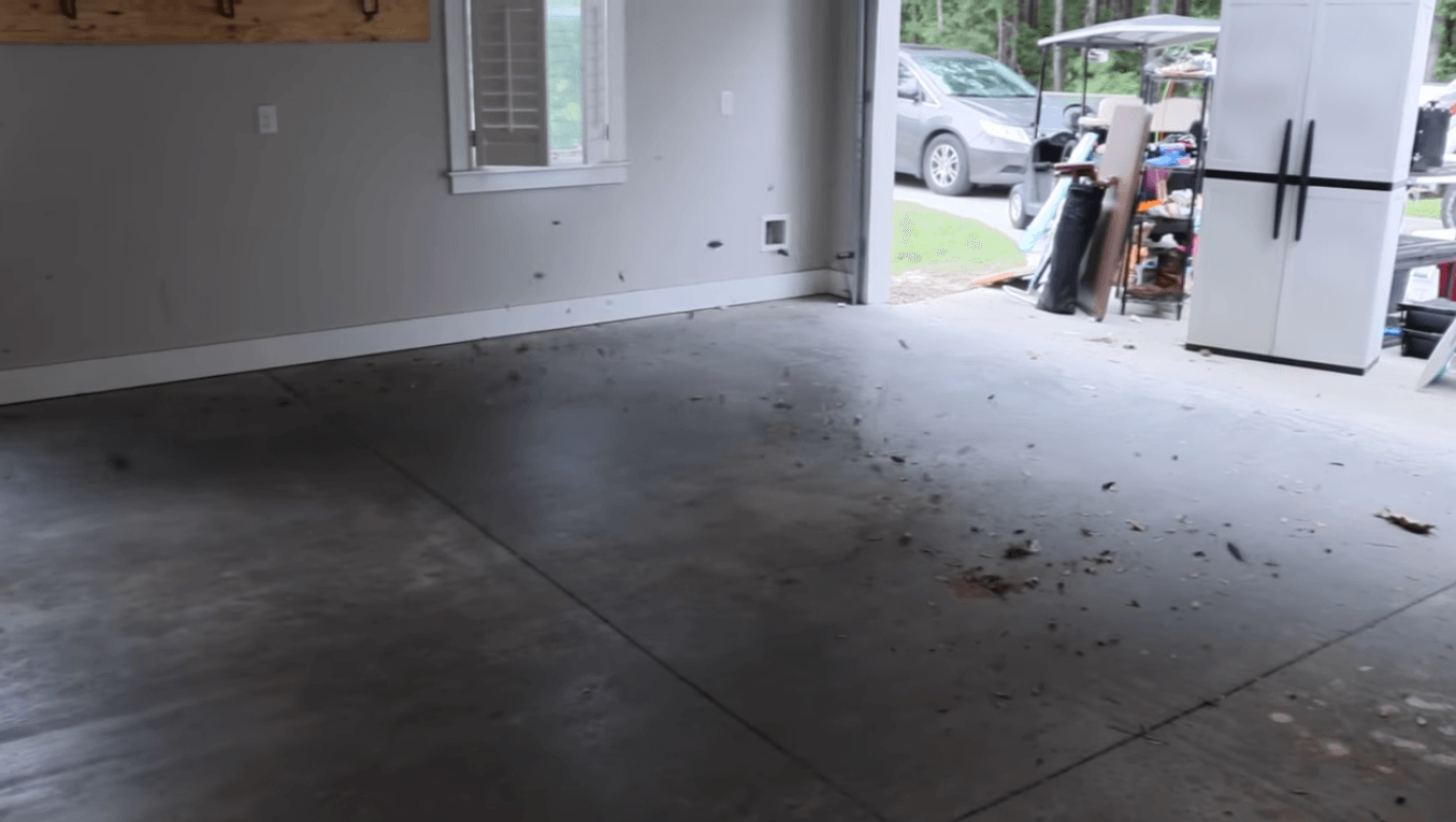 view is from inside of a recently cleaned out and swept garage. Some of the junk that is now in the driveway is still visible