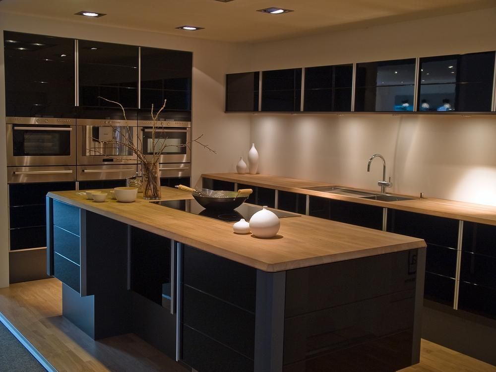 A Kitchen With Black Cabinets And A Large Island In The Middle — Viison Kitchens & Joinery Forster In Forster, NSW