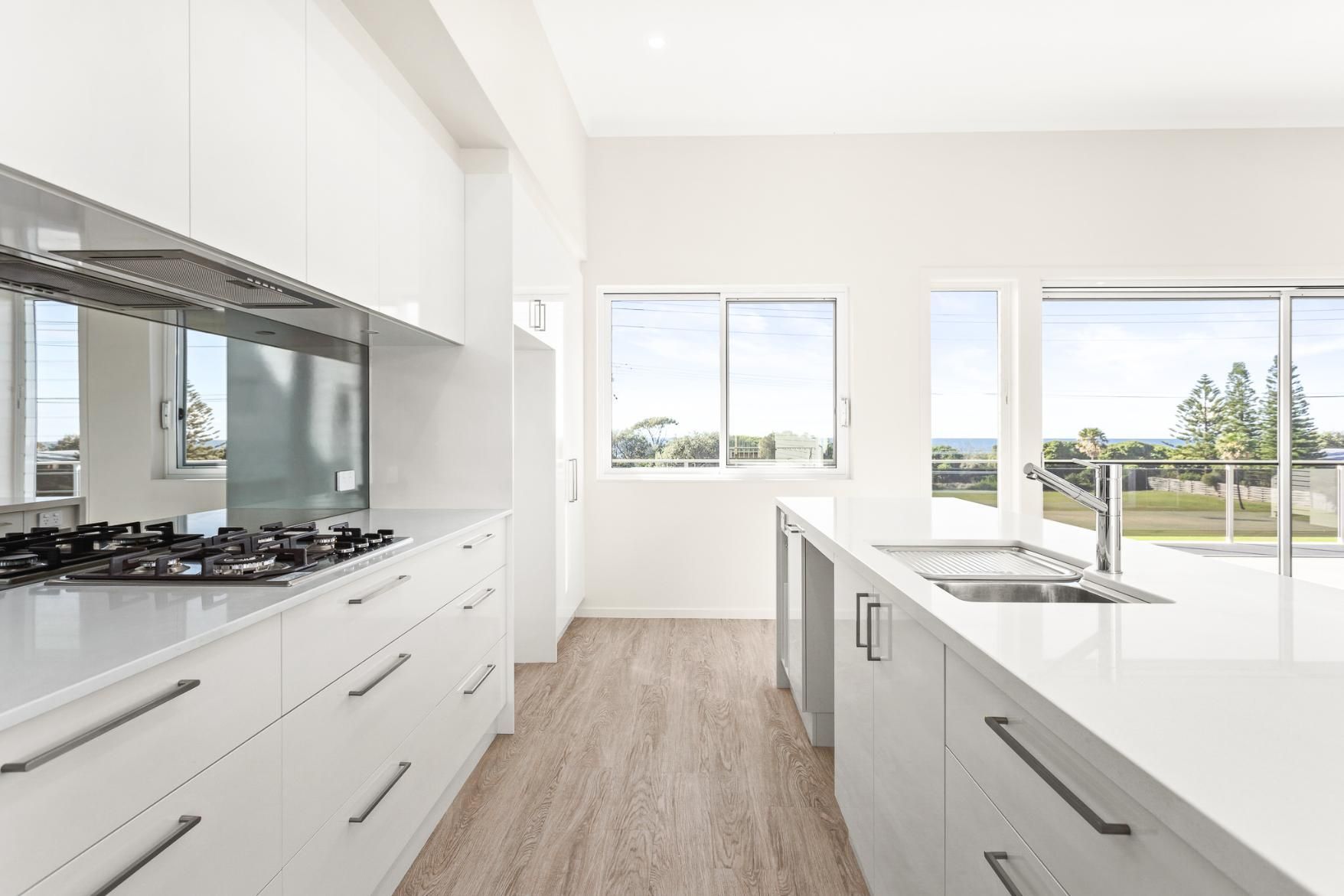 A Kitchen With White Cabinets , A Stove And A Sink — Viison Kitchens & Joinery Forster In Forster, NSW