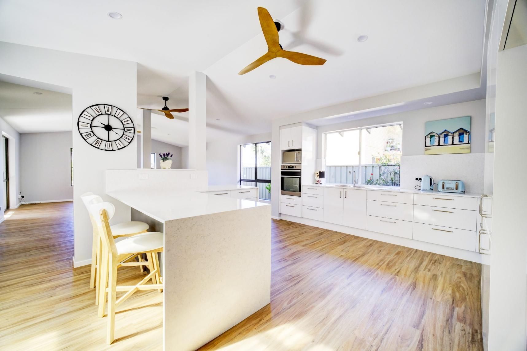 A Kitchen With A Ceiling Fan And A Clock On The Wall — Viison Kitchens & Joinery Forster In Forster, NSW