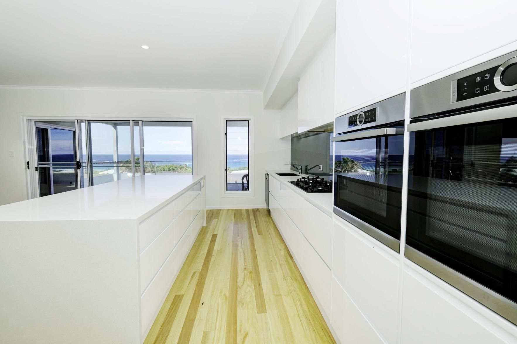 A Kitchen With White Cabinets And Stainless Steel Appliances — Viison Kitchens & Joinery Forster In Forster, NSW