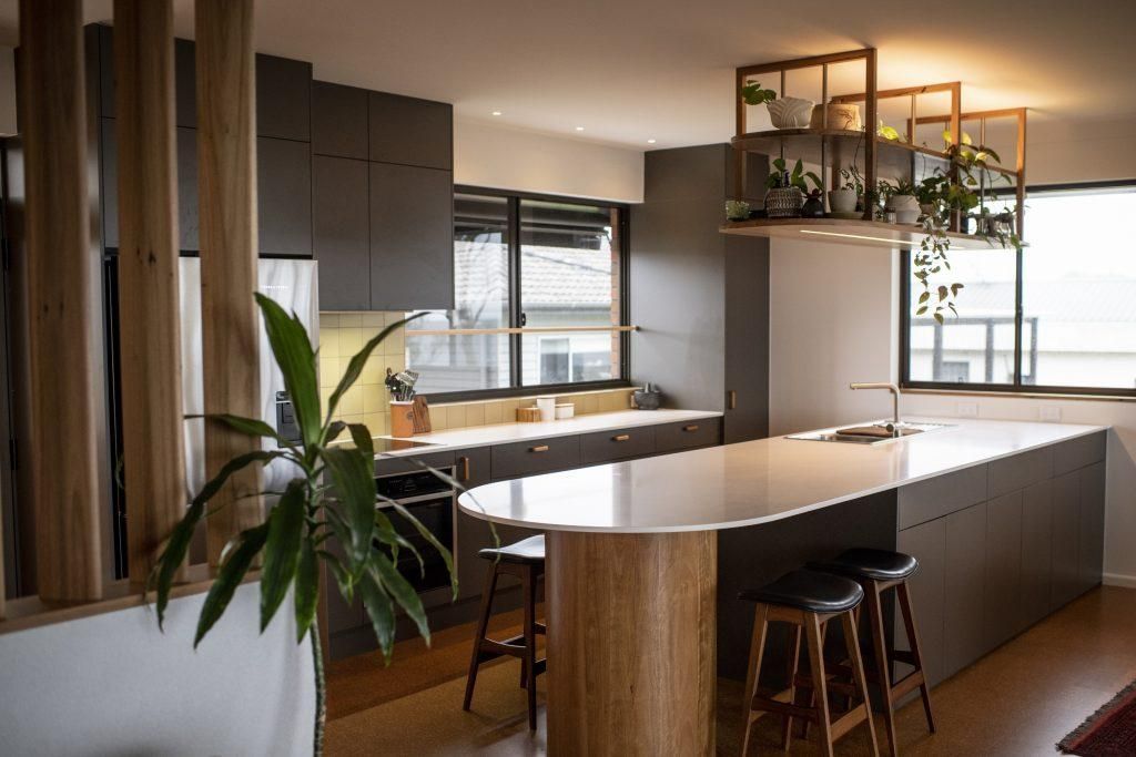 A Kitchen With A Large Island , Stools And A Plant — Viison Kitchens & Joinery Forster In Forster, NSW