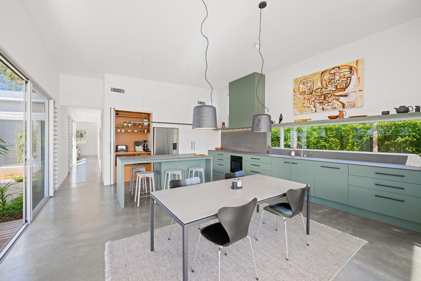 A Kitchen With A Table And Chairs In It — Viison Kitchens & Joinery Forster In Forster, NSW