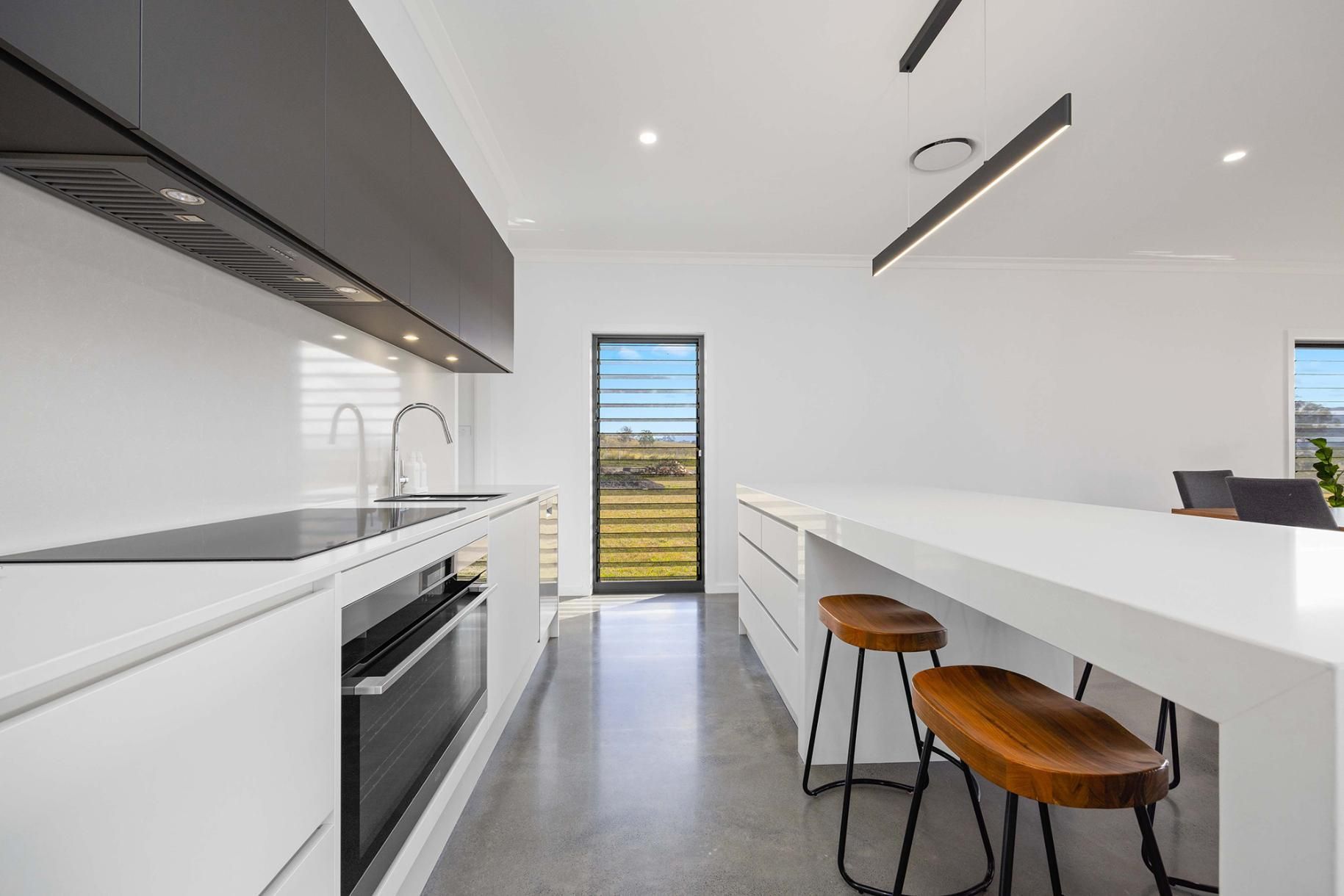 A Kitchen With Cabinets ,Appliances , A Large Island And Stools — Viison Kitchens & Joinery Forster In Forster, NSW