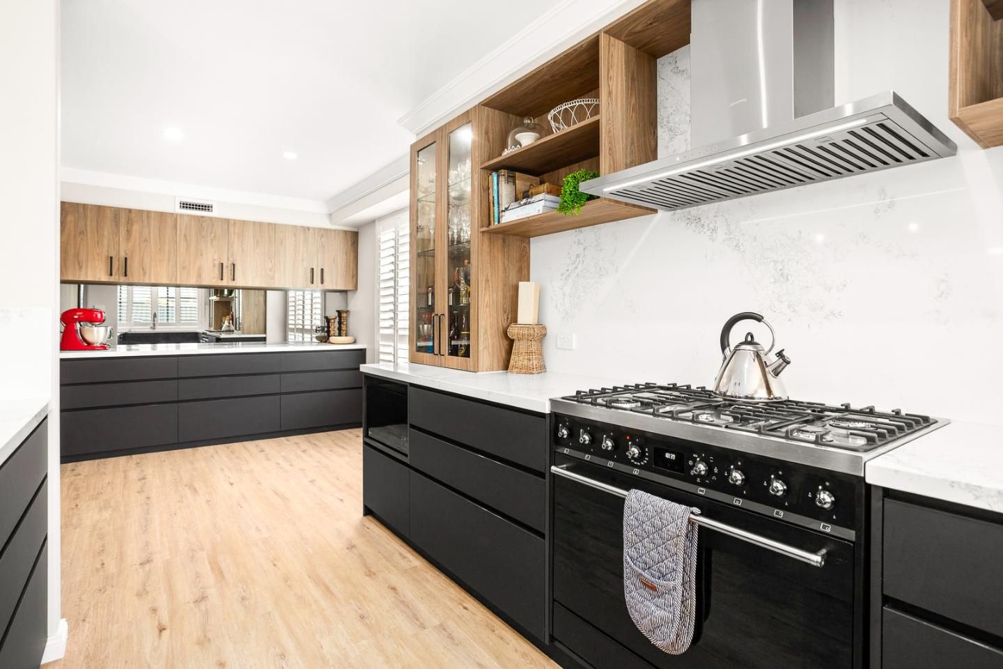 A Kitchen With Black Cabinets And A Stove Top Oven — Viison Kitchens & Joinery Forster In Forster, NSW