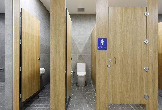 A public restroom with wooden dividers and a toilet. — Viison Kitchens & Joinery Forster In Port Macquarie, NSW