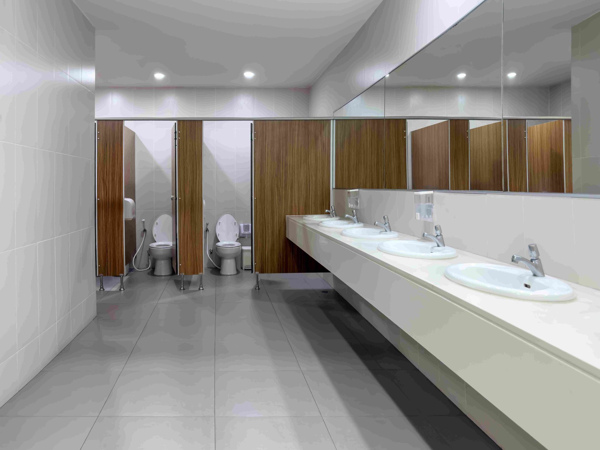 A public restroom with toilets , sinks and mirrors. — Viison Kitchens & Joinery Forster In Gloucester, NSW