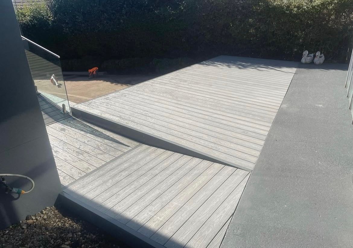 Ramp leading to a paved area with a textured surface, likely for accessibility, in an outdoor setting. — Hallam & Sons in Beard, ACT