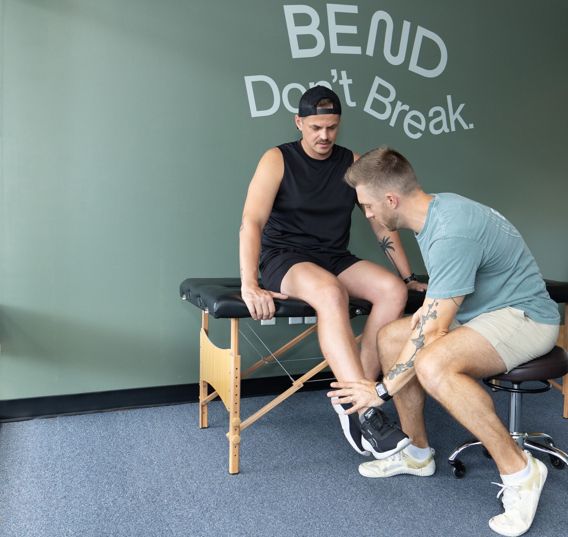 Patient receiving a lower leg assessment from a physical therapist at a running physical therapy clinic in Henrico, VA