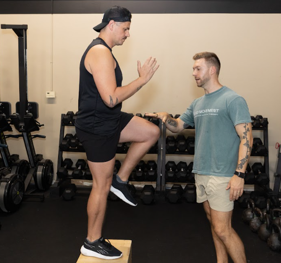 Physical therapist in Richmond performing one-on-one functional movement assessment with athlete for performance optimization