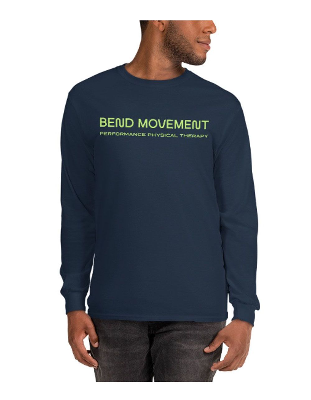 Man wearing a navy long-sleeve shirt with green “BEYOND MOVEMENT” text on the chest.