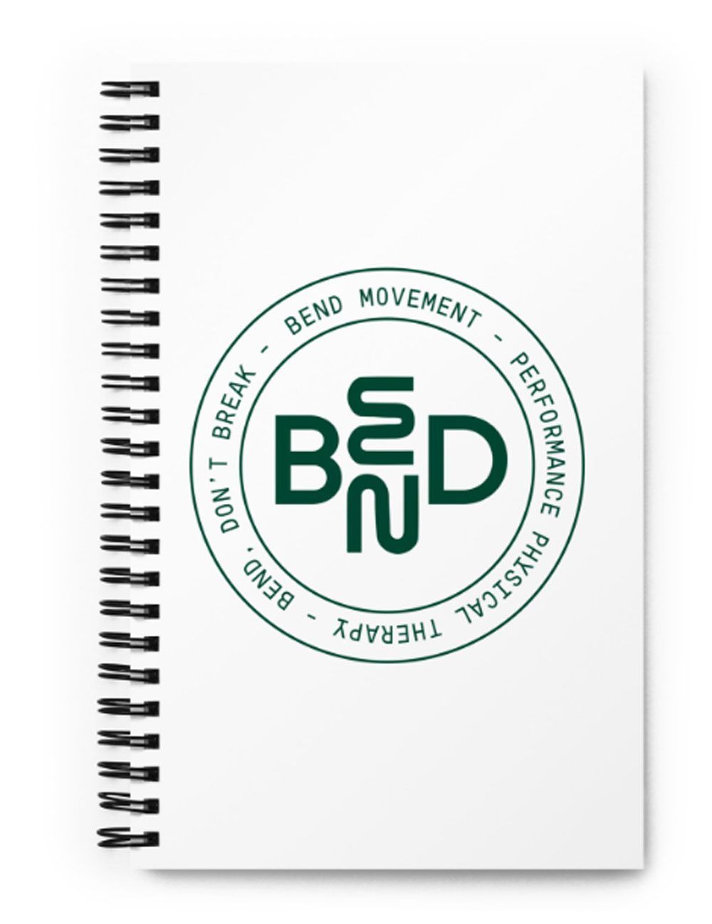 Spiral notebook with a green circular “BEND” logo and surrounding text on a white cover