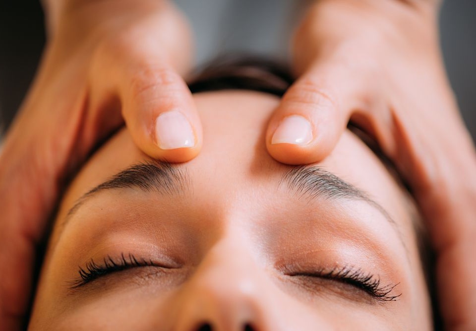 Woman receiving a cranial sacral massage.