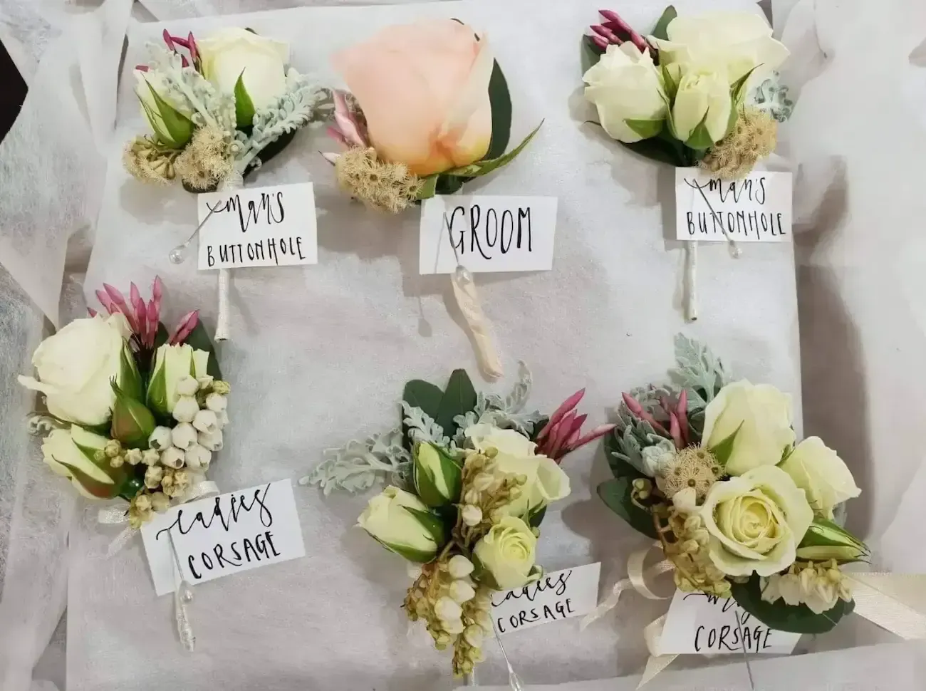 Boutonnieres with floral arrangements, labeled 