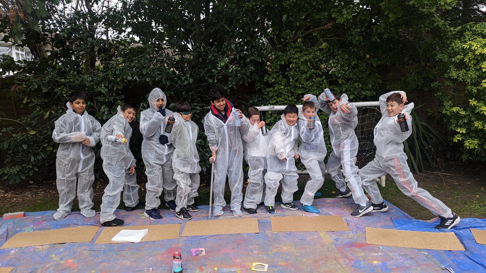 Boys posing with spray paint cans at a graffiti birthday party in London