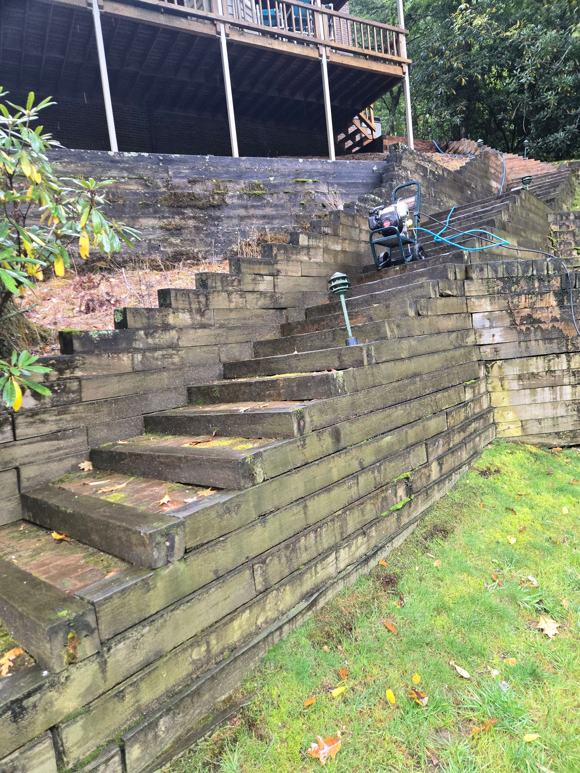 A brick wall with stairs leading up to a house.